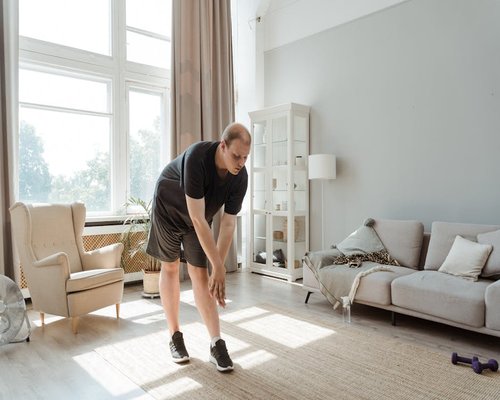 Person doing a light stretching exercise in a living room